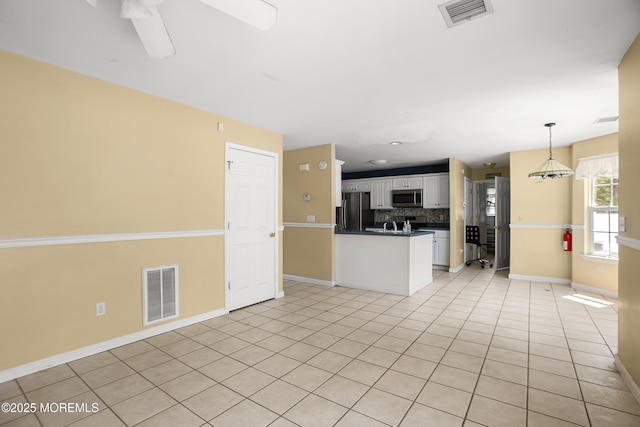 4 Frankies Ln, Toms River, NJ 08753 - kitchen featuring stainless steel appliances, dark countertops, backsplash, white cabinetry, and baseboards