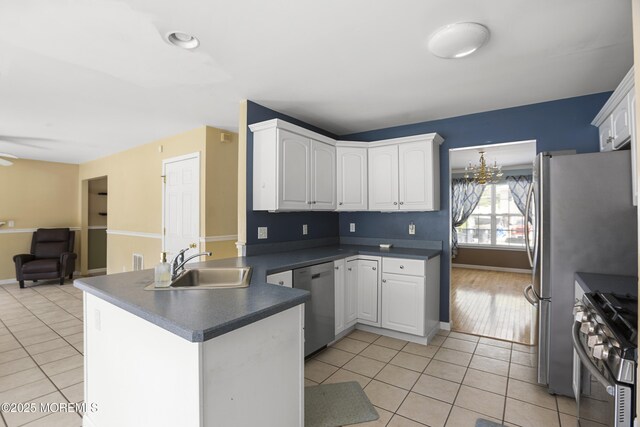4 Frankies Ln, Toms River, NJ 08753 - kitchen with appliances with stainless steel finishes, a peninsula, dark countertops, and light tile patterned floors