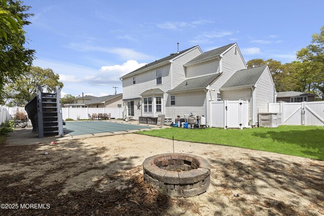 4 Frankies Ln, Toms River, NJ 08753 - back of house with a gate, a fire pit, a patio area, and a shingled roof