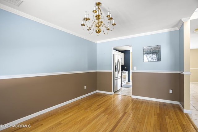 4 Frankies Ln, Toms River, NJ 08753 - empty room featuring light wood-type flooring, a chandelier, baseboards, and crown molding