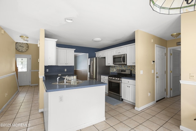 4 Frankies Ln, Toms River, NJ 08753 - kitchen featuring appliances with stainless steel finishes, a sink, light tile patterned flooring, a peninsula, and white cabinets