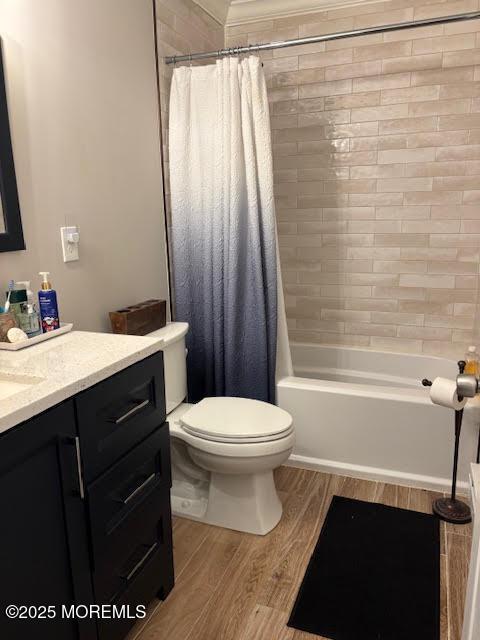 bathroom featuring shower / tub combo, wood finished floors, toilet, and vanity
