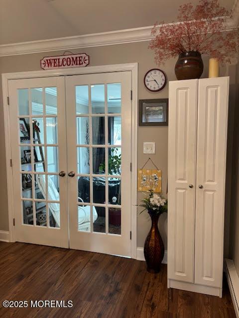 doorway to outside with dark wood-style flooring, french doors, ornamental molding, and baseboards