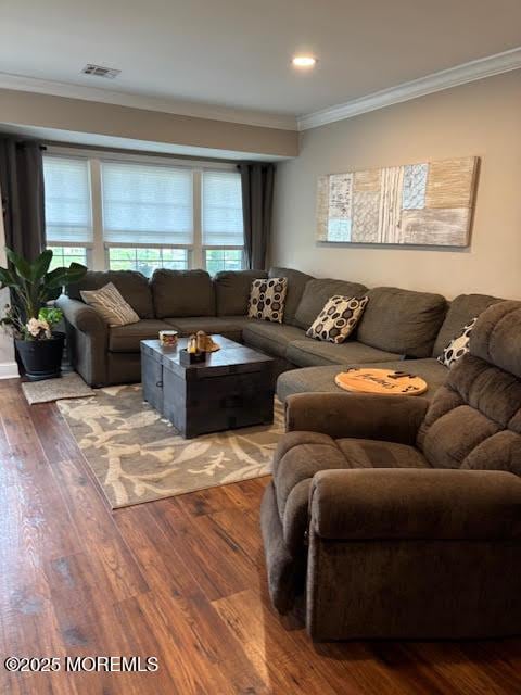 living area featuring ornamental molding, recessed lighting, visible vents, and wood finished floors