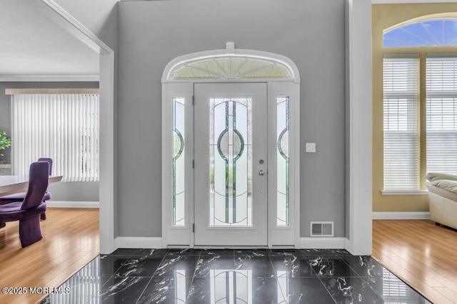 entryway with marble finish floor, visible vents, and baseboards