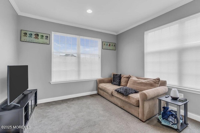 carpeted living area featuring crown molding and baseboards