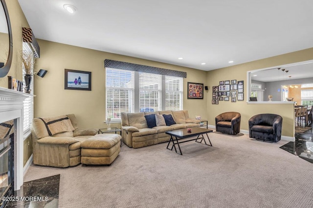 living room with recessed lighting, a fireplace with flush hearth, baseboards, and carpet floors
