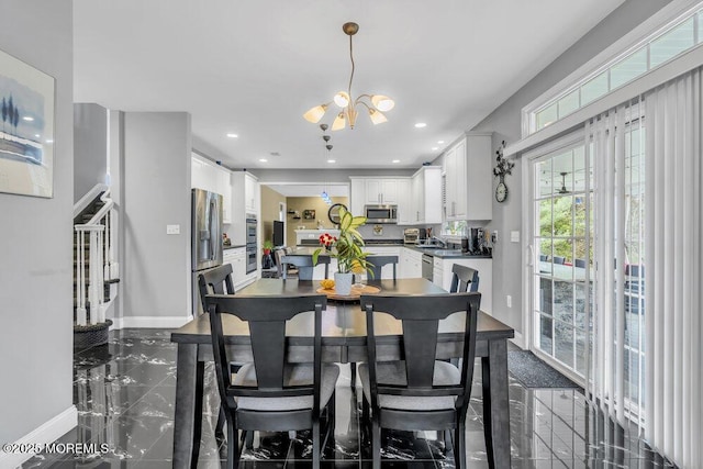 dining room featuring a notable chandelier, baseboards, and recessed lighting
