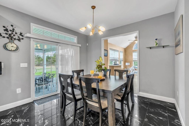 dining room with marble finish floor, baseboards, and a healthy amount of sunlight