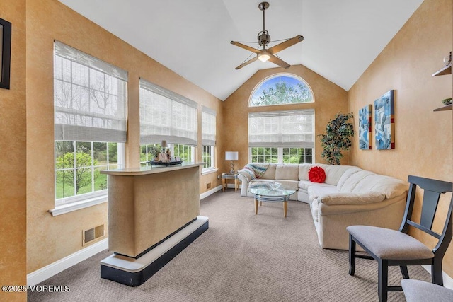 carpeted living room featuring a healthy amount of sunlight, baseboards, a ceiling fan, and visible vents