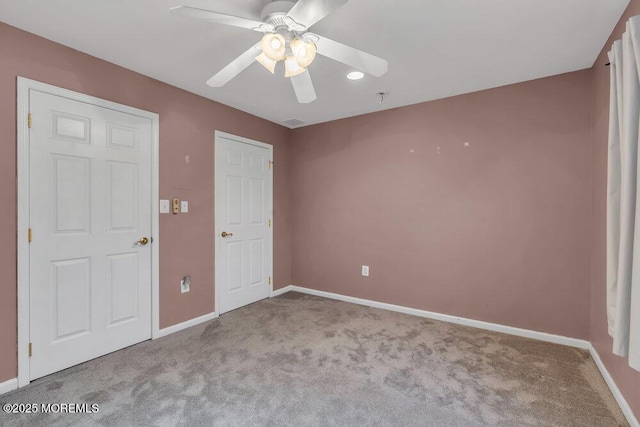 unfurnished bedroom featuring baseboards, carpet flooring, and ceiling fan