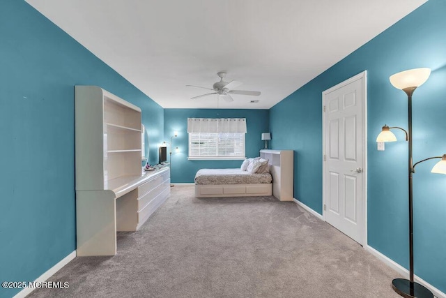 unfurnished bedroom featuring carpet flooring, baseboards, and ceiling fan