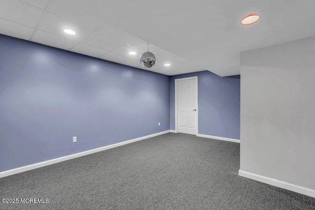 spare room with dark carpet, baseboards, recessed lighting, and a paneled ceiling