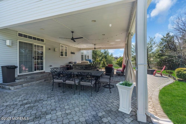 view of patio with a ceiling fan and outdoor dining area