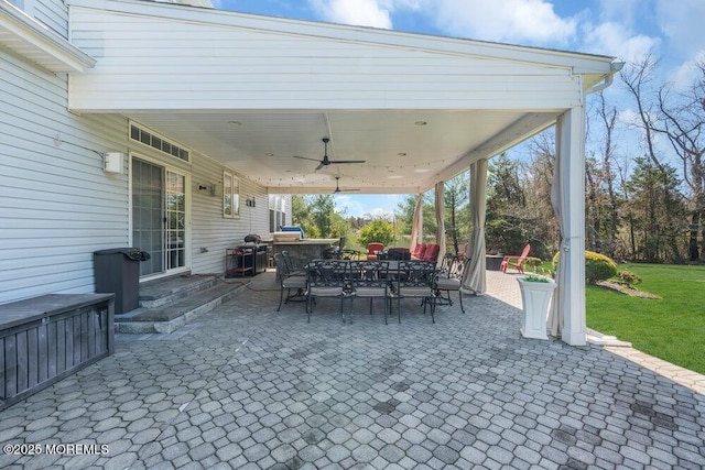 view of patio with a ceiling fan and outdoor dining area