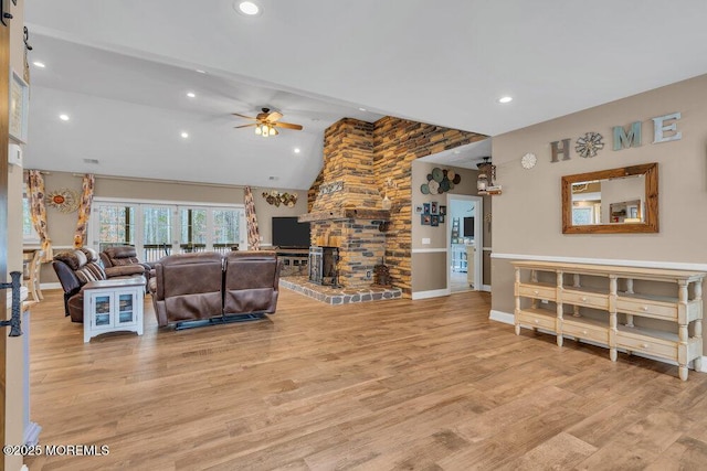 living room with baseboards, ceiling fan, recessed lighting, vaulted ceiling, and light wood-style flooring