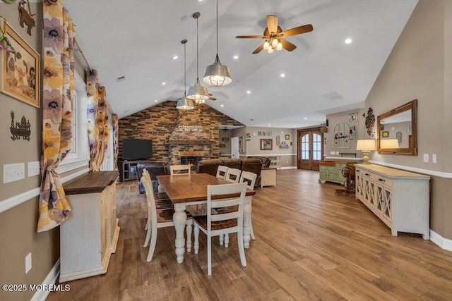 dining area with a ceiling fan, recessed lighting, wood finished floors, lofted ceiling, and baseboards