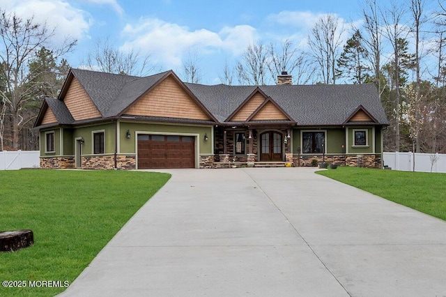 craftsman house featuring a front lawn, fence, a garage, and driveway