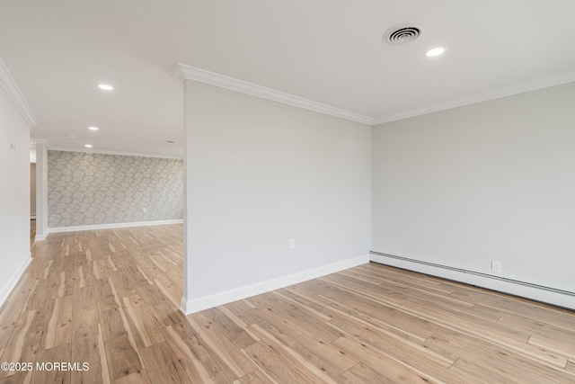 spare room with baseboard heating, light wood-type flooring, wallpapered walls, crown molding, and visible vents
