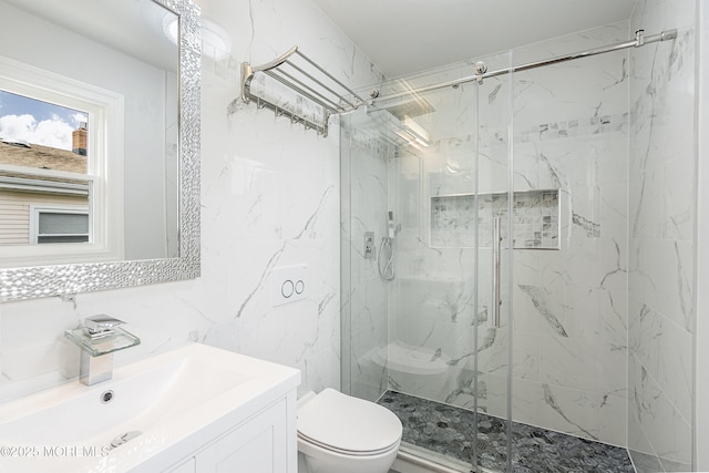 full bathroom with a marble finish shower, tile walls, toilet, and vanity