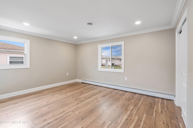interior space with baseboard heating, crown molding, light wood finished floors, and plenty of natural light