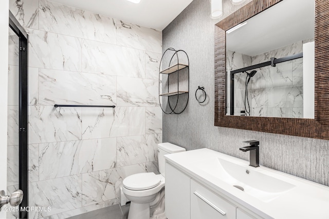 bathroom with toilet, a stall shower, and vanity