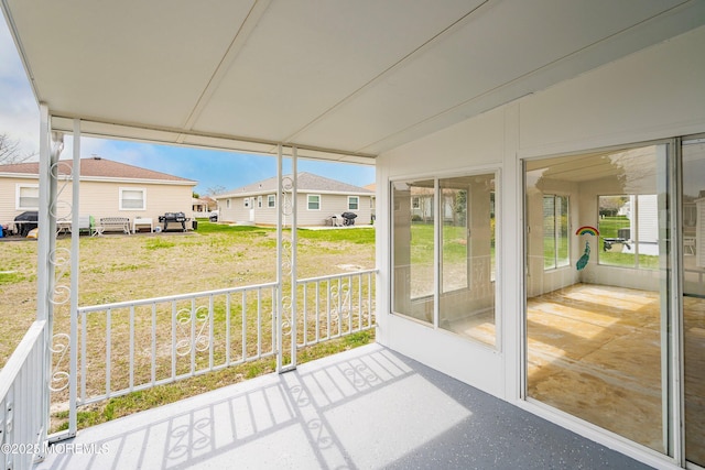 unfurnished sunroom featuring a residential view