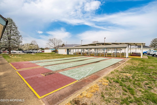 surrounding community featuring a yard and shuffleboard