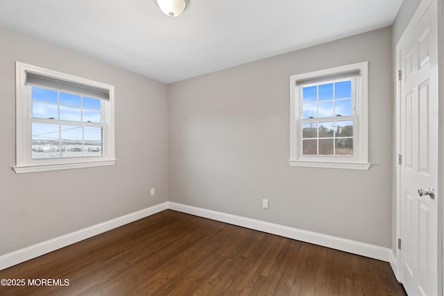 23 Island Dr, Brick, NJ 08724 - unfurnished bedroom featuring a closet, multiple windows, baseboards, and dark wood-style floors