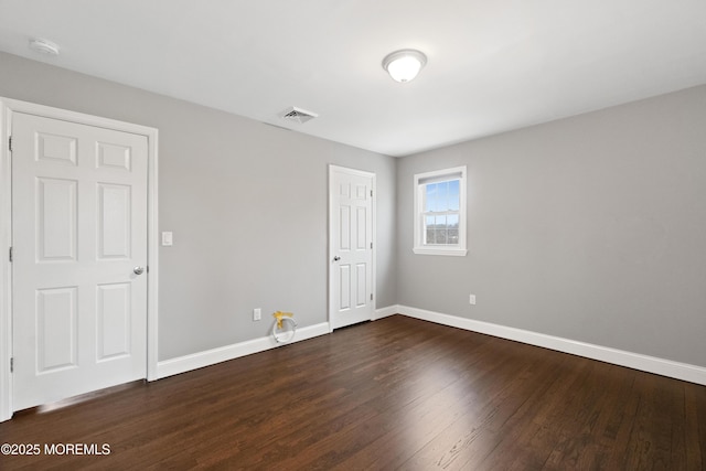 23 Island Dr, Brick, NJ 08724 - unfurnished bedroom with visible vents, baseboards, and dark wood finished floors