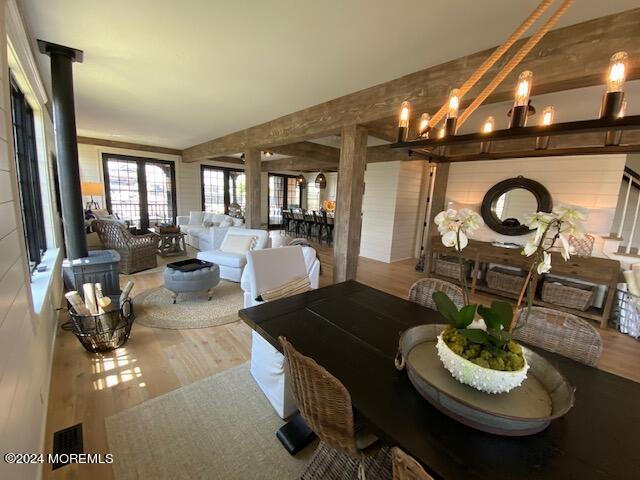 living area with wood finished floors and beamed ceiling