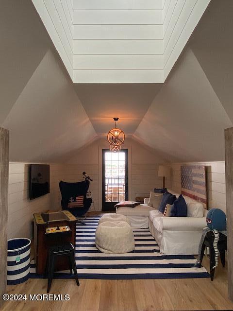 bedroom with vaulted ceiling and wood finished floors