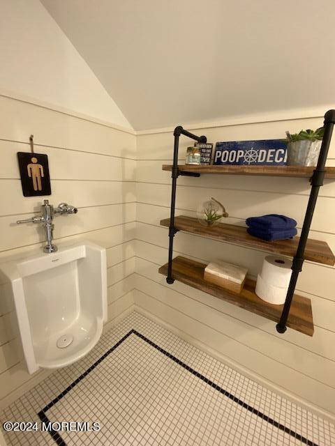 bathroom with a sink, tile patterned flooring, and vaulted ceiling