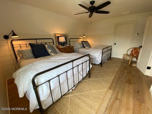 bedroom with a ceiling fan and wood finished floors