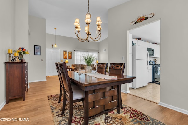 1101B Thornbury Ln, Manchester, NJ 08759 - dining area featuring baseboards, a towering ceiling, an inviting chandelier, and light wood-style floors