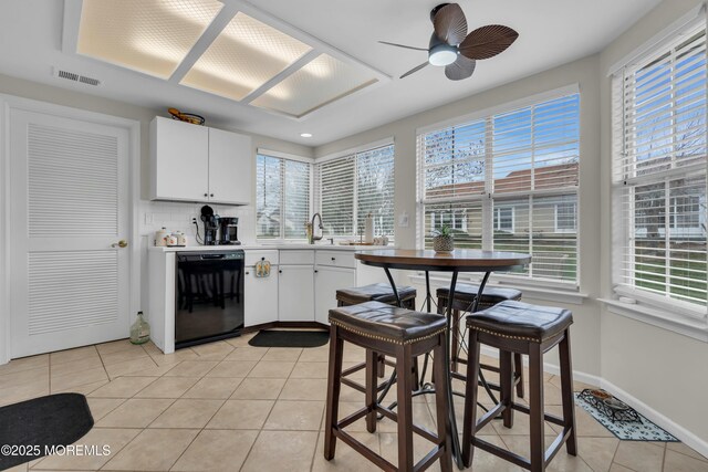 1101B Thornbury Ln, Manchester, NJ 08759 - kitchen featuring black dishwasher, a healthy amount of sunlight, light tile patterned flooring, and visible vents