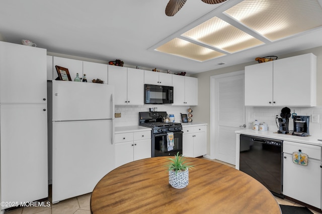 1101B Thornbury Ln, Manchester, NJ 08759 - kitchen with white cabinets, light countertops, black appliances, and backsplash