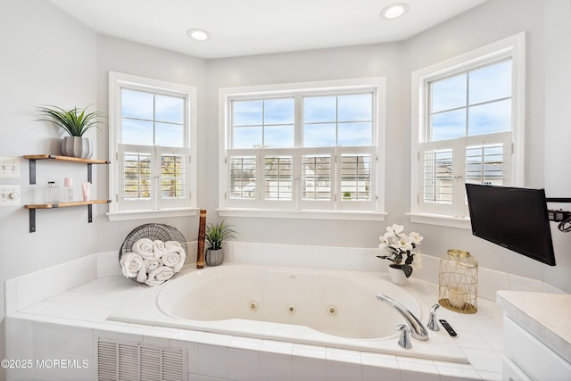 full bathroom with visible vents and a jetted tub