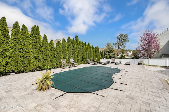 view of pool featuring a patio, fence, and a fenced in pool