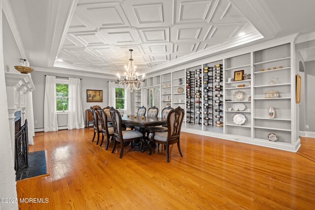 491 Clinton Ave, Toms River, NJ 08753 - dining room featuring a chandelier, light wood finished floors, a premium fireplace, a baseboard heating unit, and an ornate ceiling