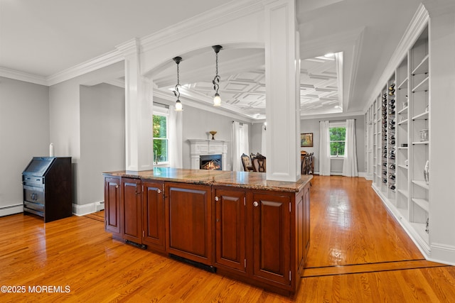 491 Clinton Ave, Toms River, NJ 08753 - kitchen with light wood-style floors, stone counters, a warm lit fireplace, ornamental molding, and decorative light fixtures