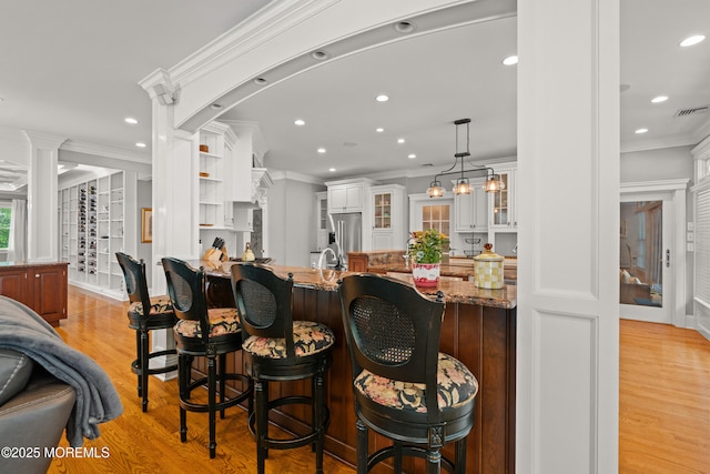 491 Clinton Ave, Toms River, NJ 08753 - kitchen with light wood finished floors, recessed lighting, glass insert cabinets, ornamental molding, and stainless steel refrigerator with ice dispenser