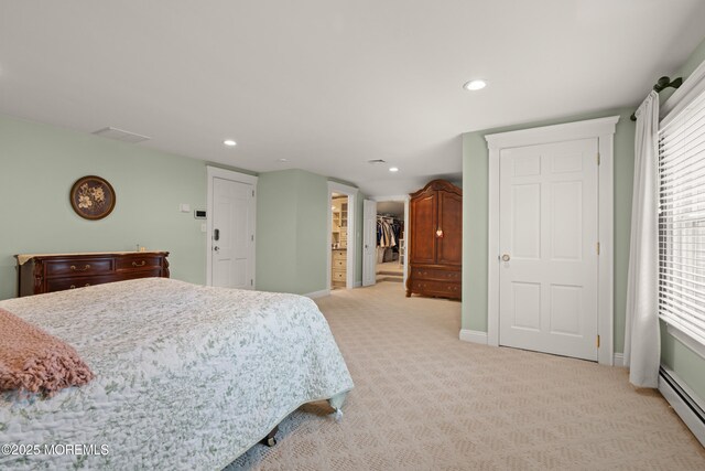 491 Clinton Ave, Toms River, NJ 08753 - bedroom featuring baseboard heating, light colored carpet, recessed lighting, baseboards, and a walk in closet