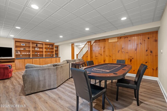 491 Clinton Ave, Toms River, NJ 08753 - dining room with light wood-style floors, stairway, wood walls, recessed lighting, and baseboards
