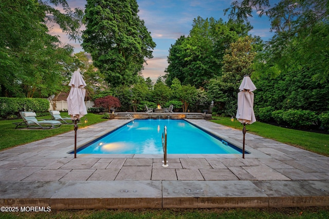 491 Clinton Ave, Toms River, NJ 08753 - pool at dusk featuring a patio, an outdoor pool, and a yard
