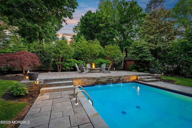 491 Clinton Ave, Toms River, NJ 08753 - pool at dusk with a fire pit, an outdoor pool, and a patio