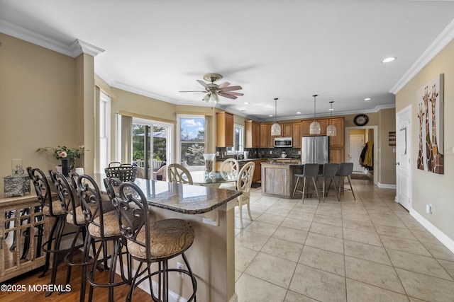 5 Breckenridge Ct, Freehold, NJ 07728 - kitchen featuring a ceiling fan, a breakfast bar, stainless steel appliances, decorative backsplash, and recessed lighting