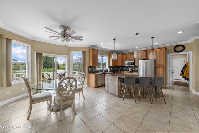 5 Breckenridge Ct, Freehold, NJ 07728 - kitchen with baseboards, ornamental molding, decorative backsplash, a kitchen island, and stainless steel appliances