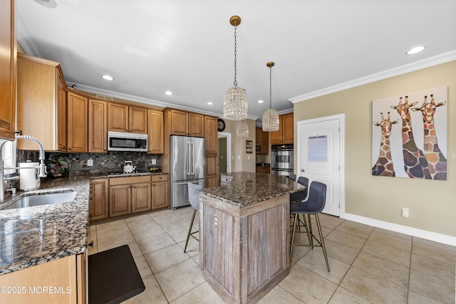 5 Breckenridge Ct, Freehold, NJ 07728 - kitchen featuring a center island, a kitchen bar, appliances with stainless steel finishes, decorative backsplash, and ornamental molding