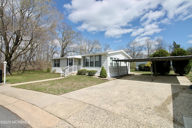 ranch-style home with a carport, concrete driveway, and a front yard